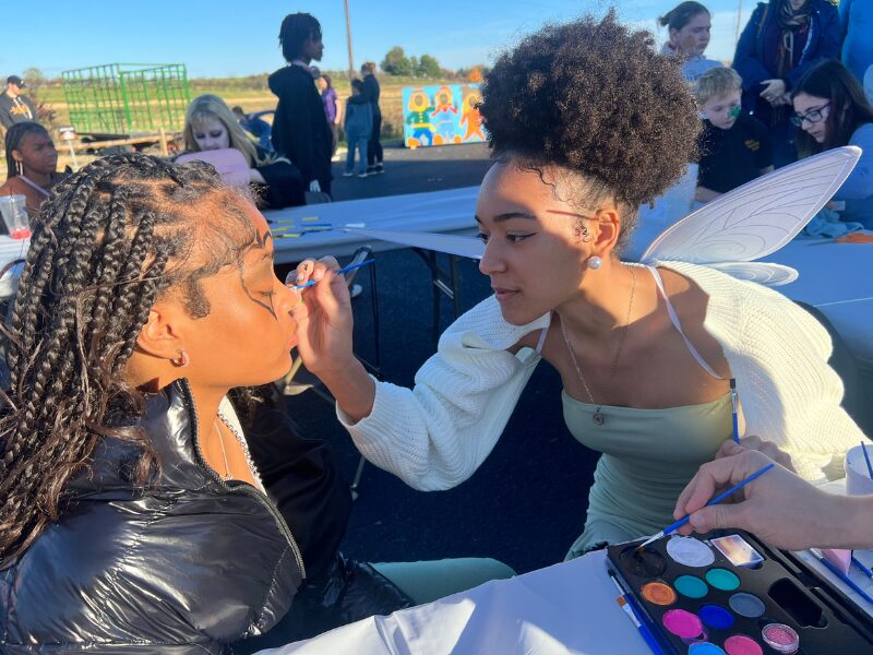 MHS art students painting faces at fall frolic