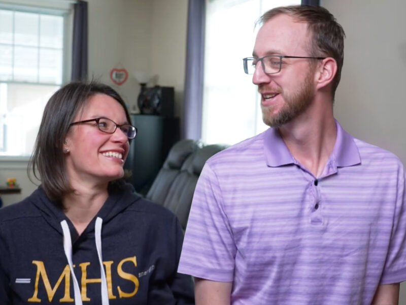 Milton Hershey School houseparents Jonathan and Ashley Cain outside of student home